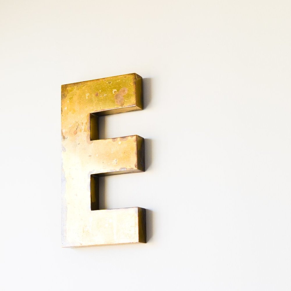 Vintage signage, brass letter 'E'